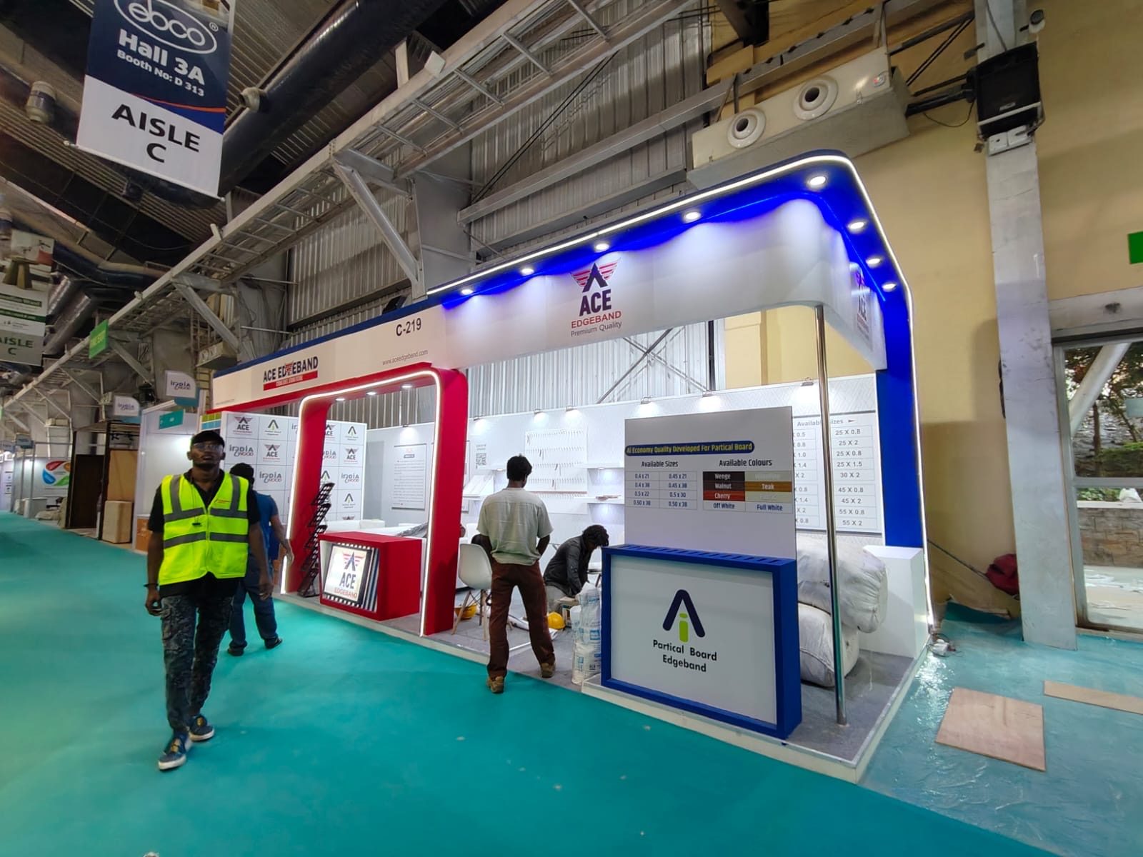 ACE Edgeband stall seen from the aisle, with the crew finishing the install