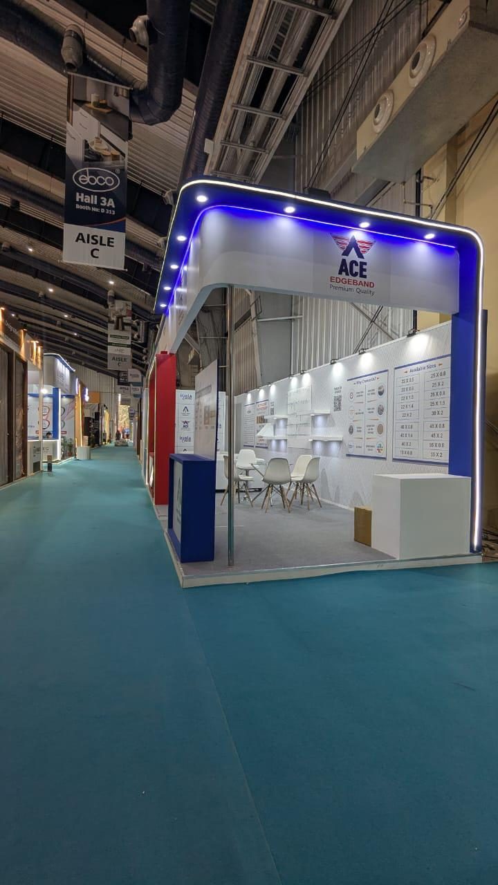 Blue LED fascia of the ACE Edgeband stall seen down the aisle