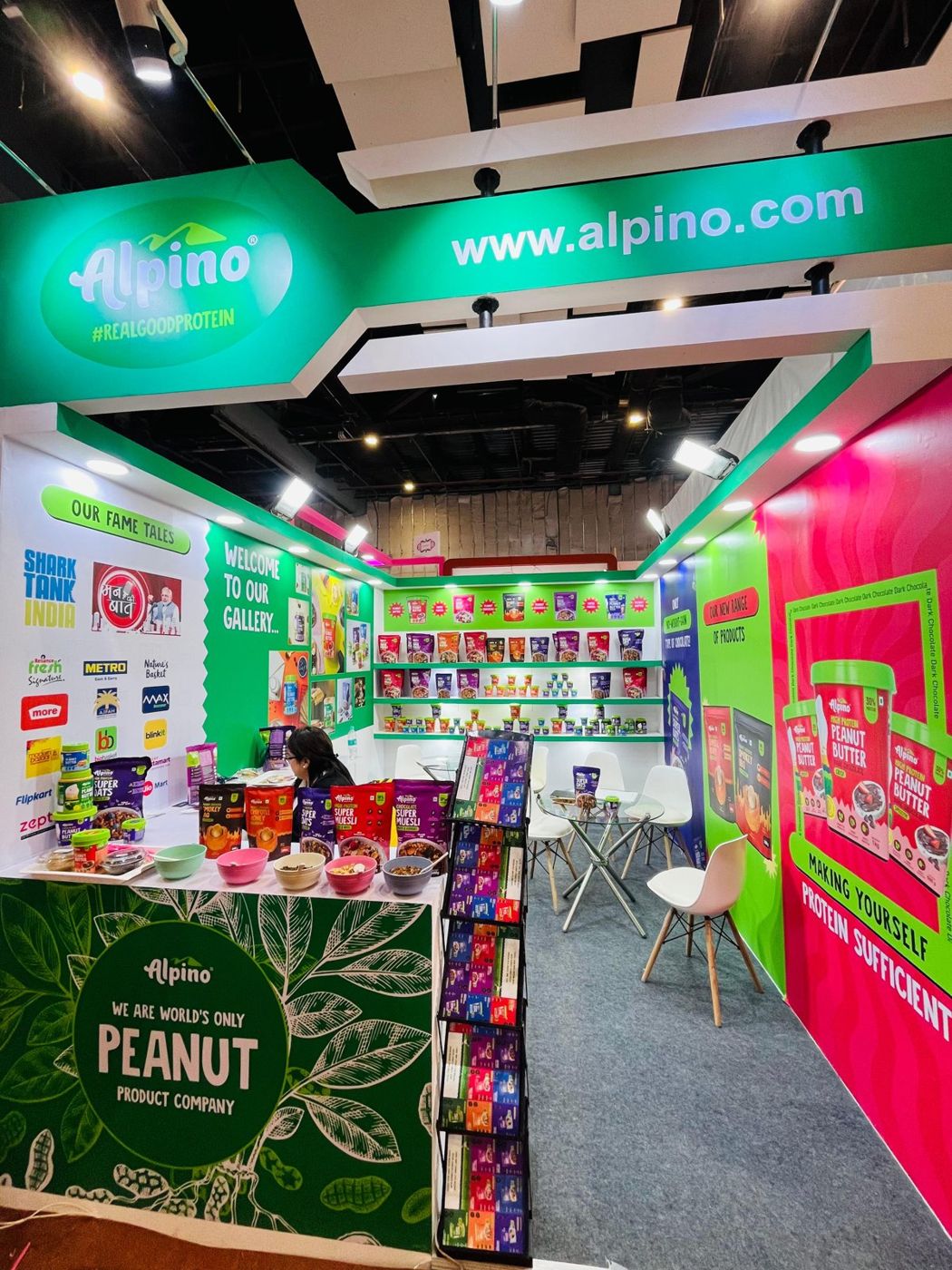 Front of the Alpino stall with green logo fascia, peanut leaf counter and pink peanut butter wall