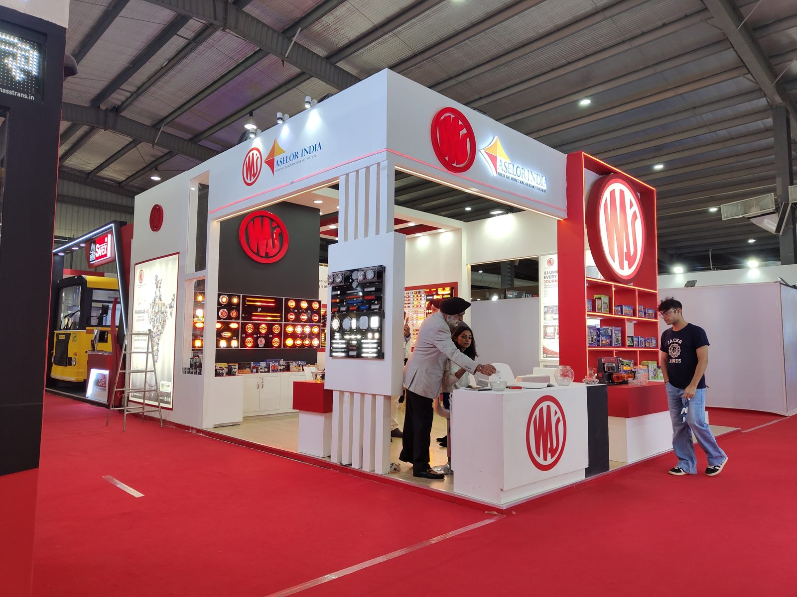 Aselor India stall from the corner, with columns, counters and red shelving