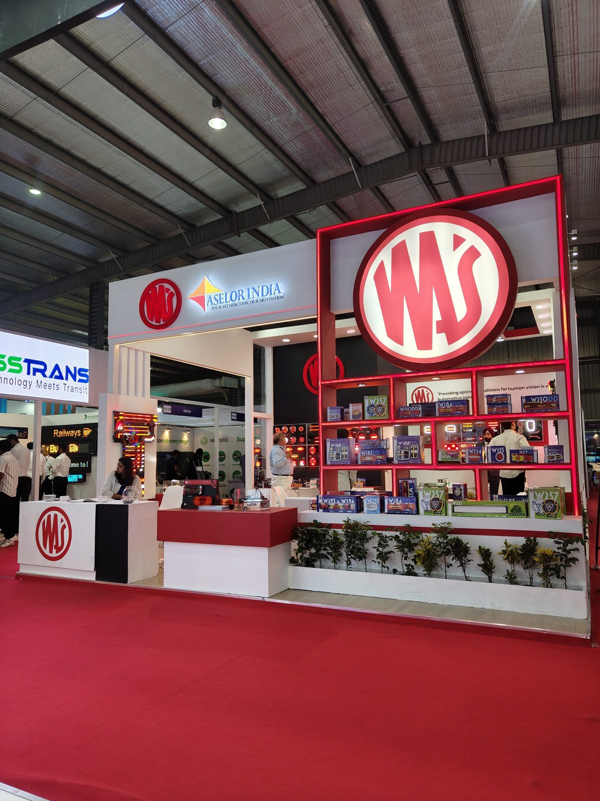 Front of the Aselor India stall with the WAS logo and planters