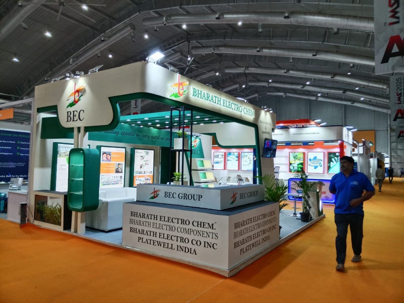BEC Group stall with curved green trim, backlit lettering and a counter naming the group companies