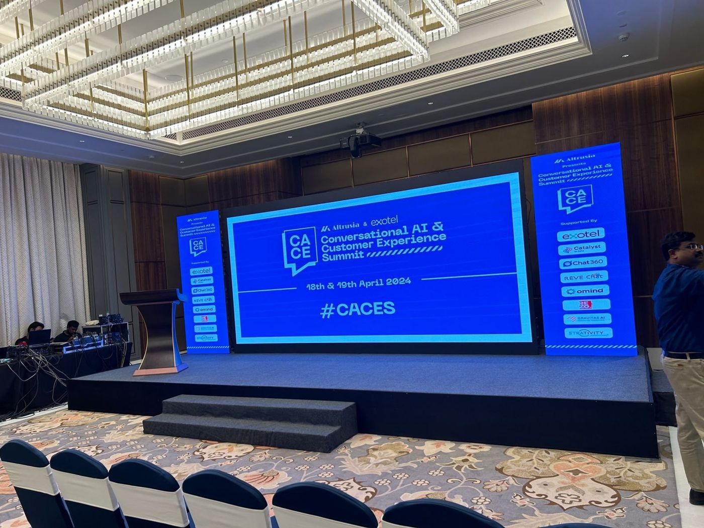 CACES stage seen from the audience seating with LED screens and black stage skirting