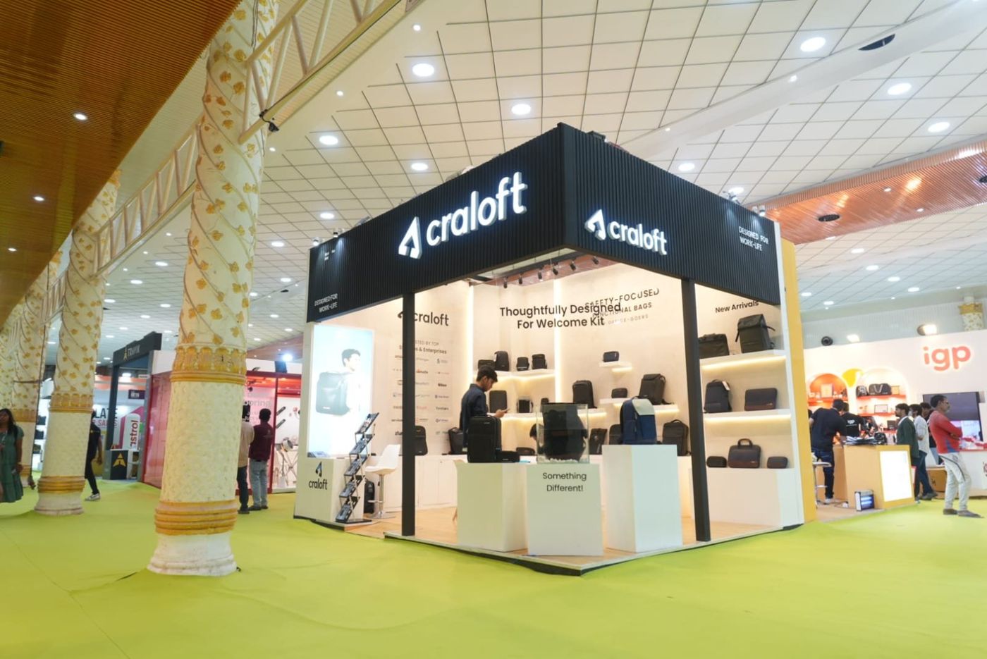 Craloft corner stall with a black fluted fascia, backlit white logo and LED lit shelves of bags and backpacks