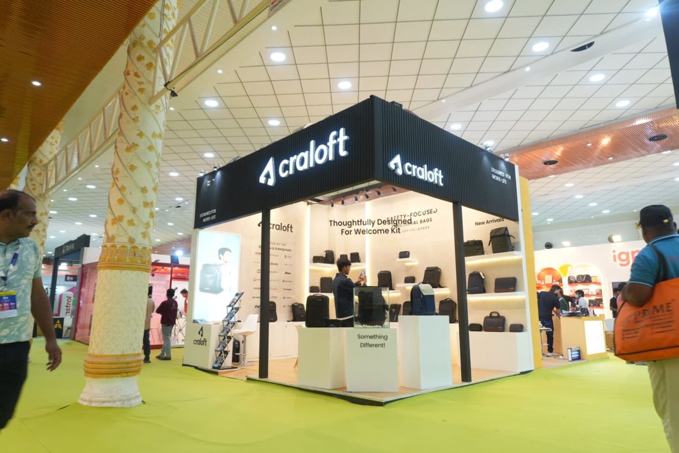 Craloft stall from the front with display plinths, an acrylic product box and a backpack lightbox