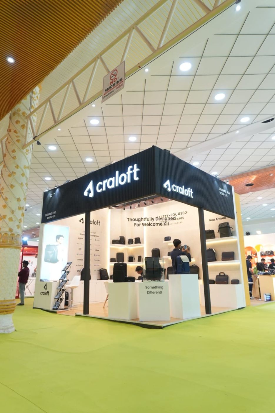 Low angle view of the Craloft stall showing the backlit fascia lettering and track spotlights