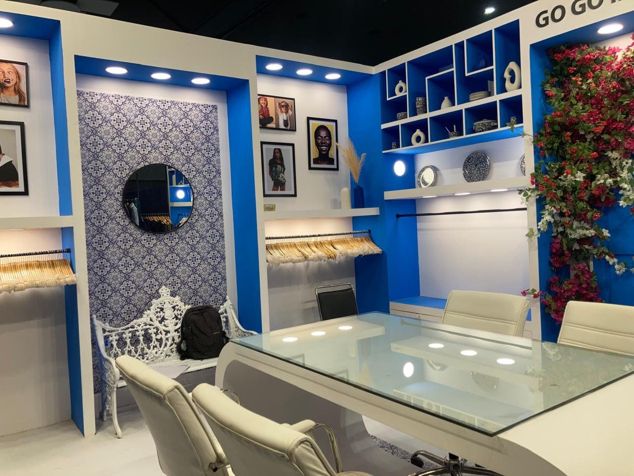 Blue and white tile pattern panel with round mirror, white cast bench and framed photos