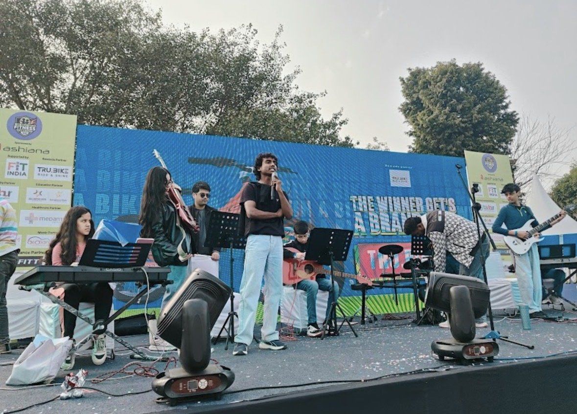 Live band performing on the carnival stage in front of the LED screen and sponsor standees