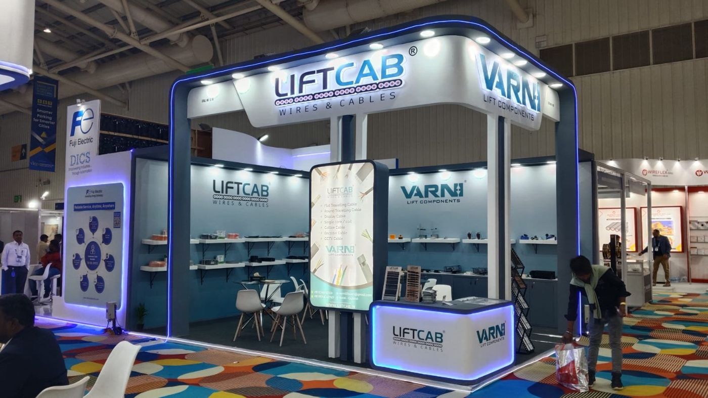 LiftCab and Varni stall with white curved fascia, blue LED edged frame, lightbox totem and product shelves