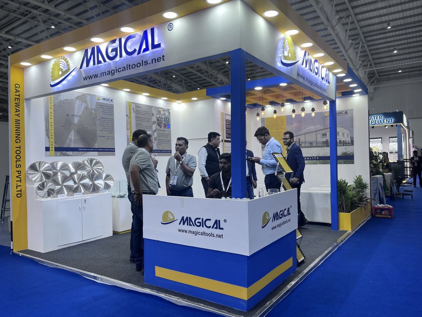 Magical corner stall with backlit blue lettering, blue column, corner counter and saw blades on display