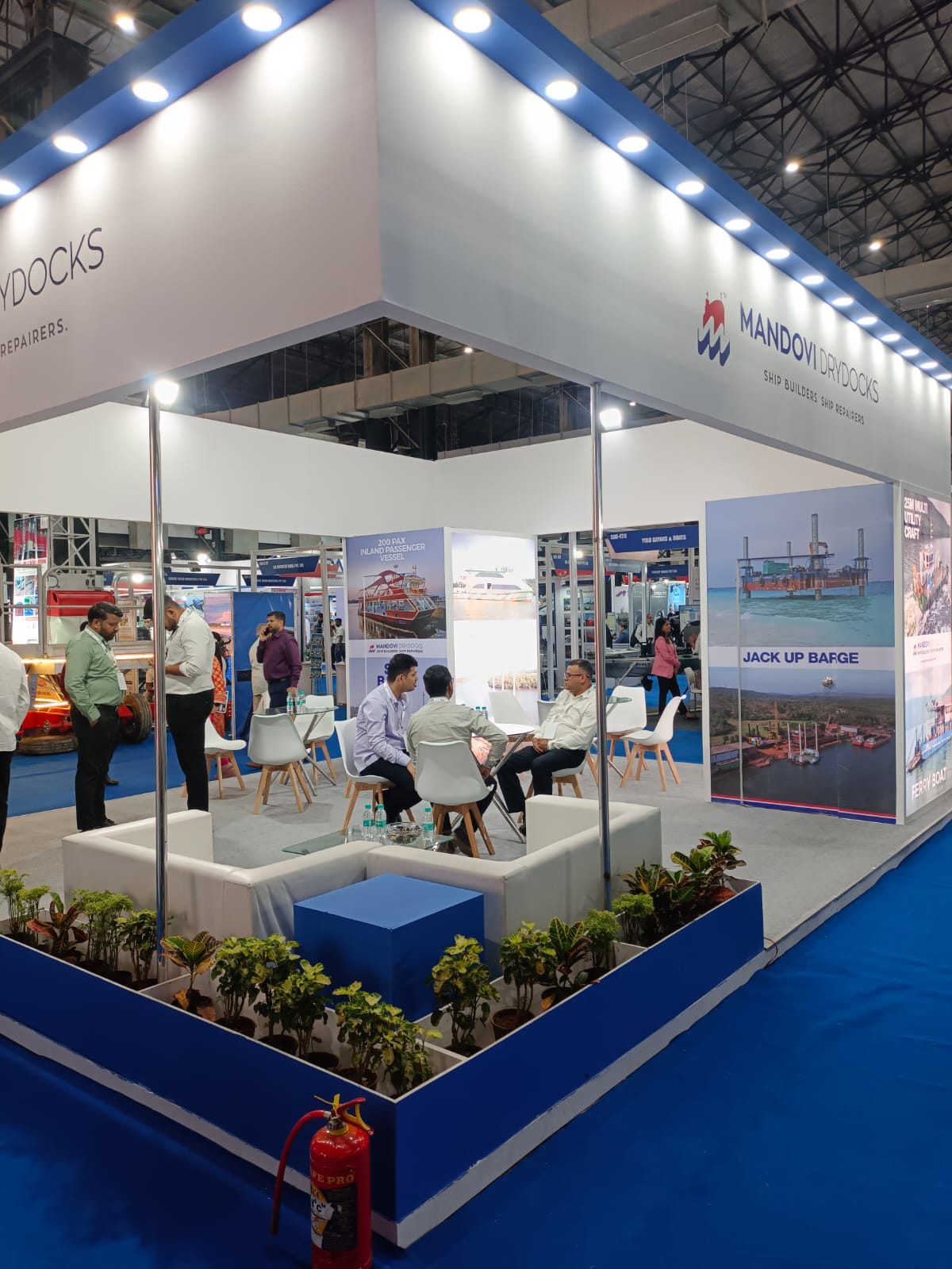 Mandovi Drydocks stall seen from the side, with visitors in the lounge