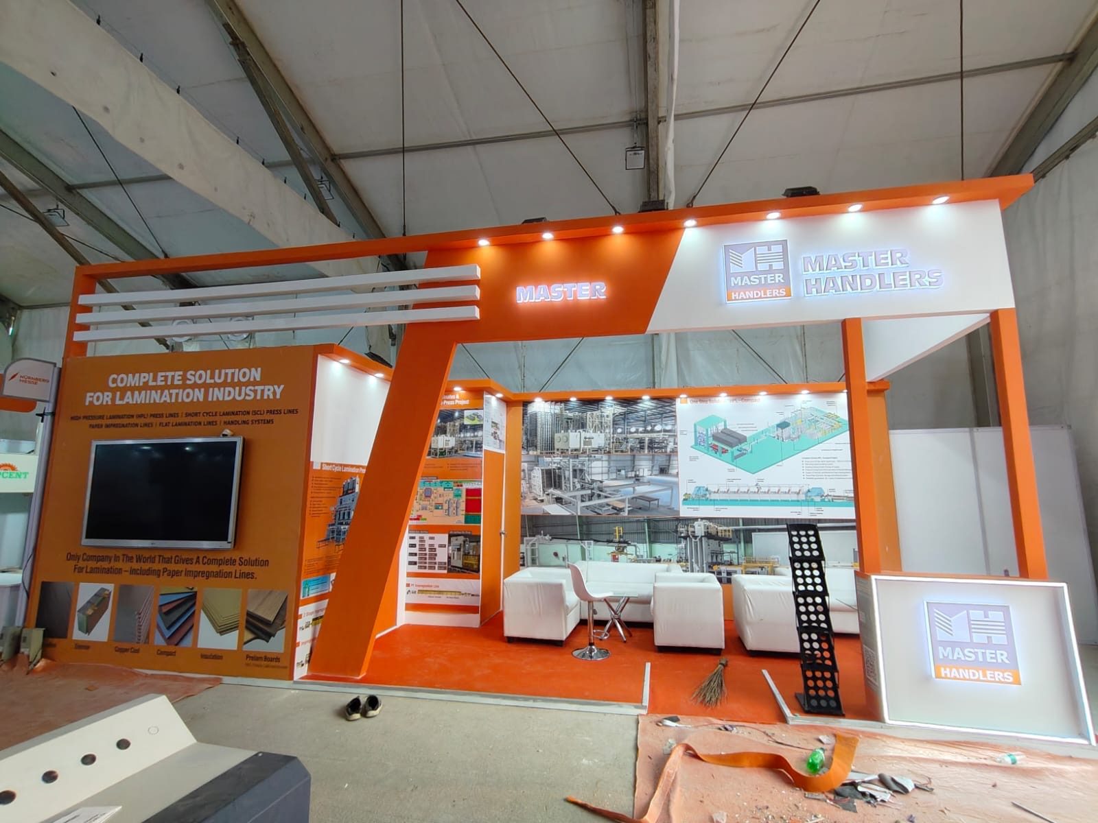 Master Handlers stall with screen wall, printed panels and lit logo cube
