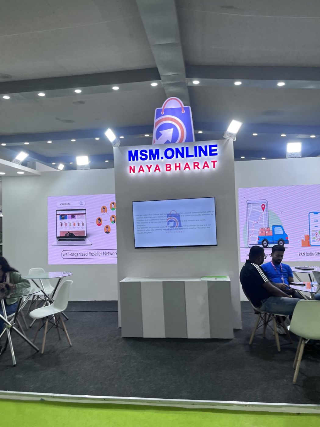 MSM Online tower with backlit letters, shopping bag logo cut-out, wall screen and striped counter