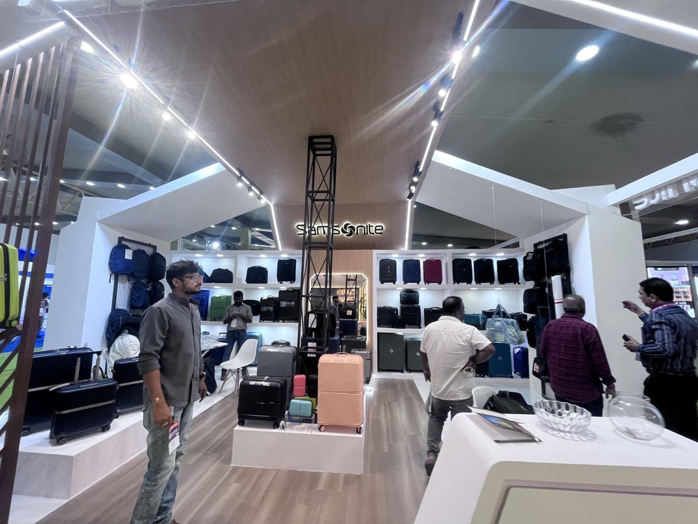 Inside the stall with timber-look gabled ceiling, black truss column and lit luggage shelving