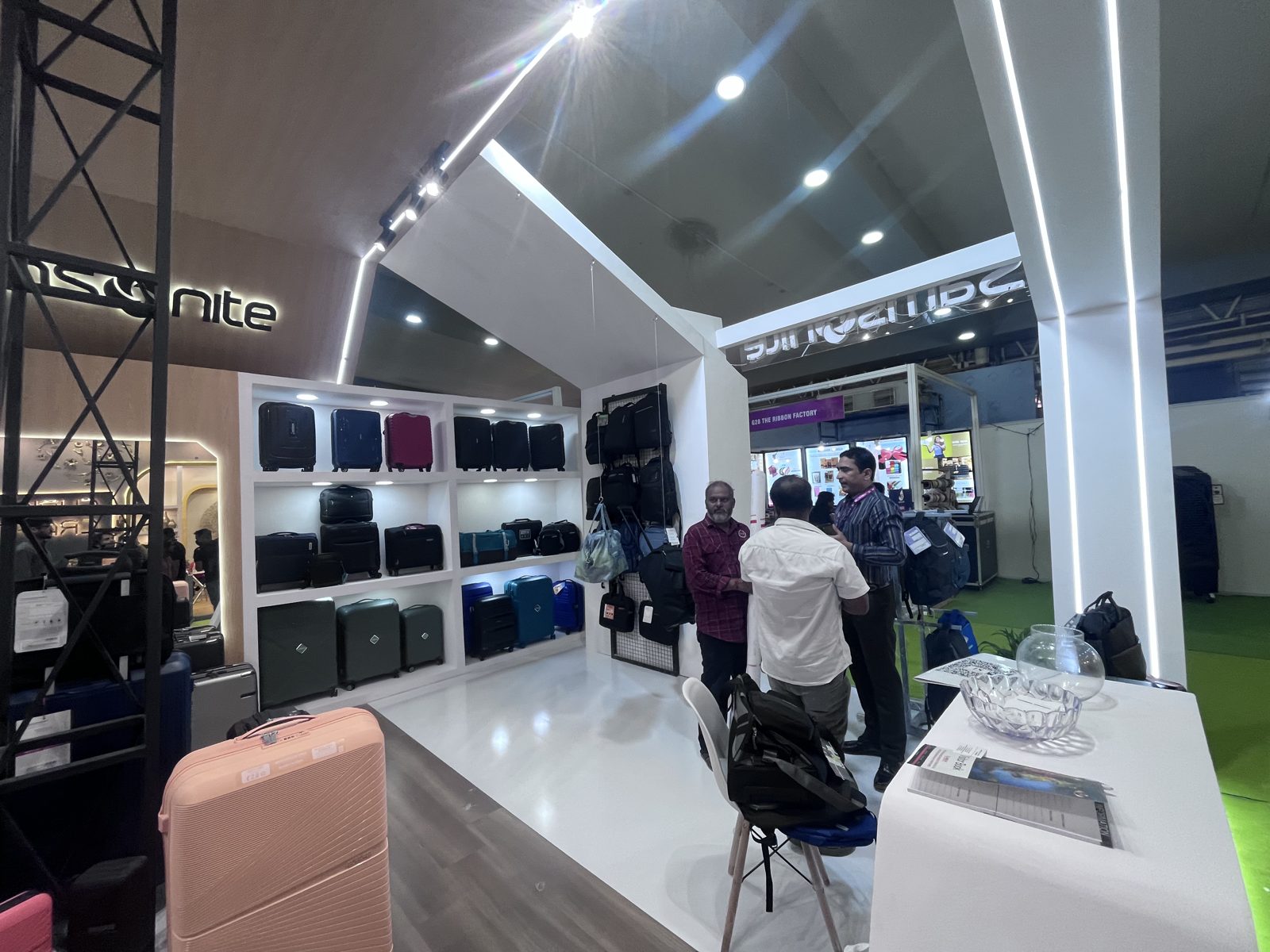 Inside the Samsonite section, white shelving with luggage and visitors